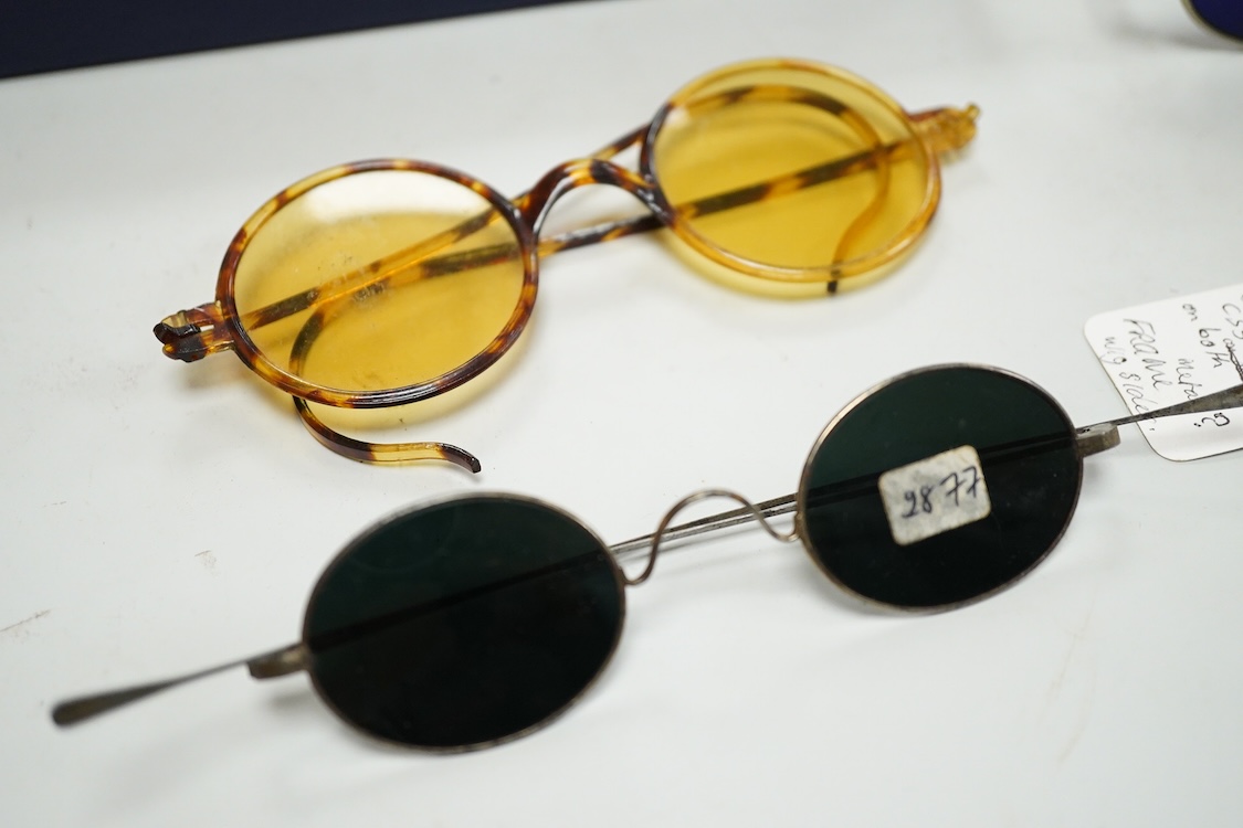 A collection of 18th-20th century steel, nickel, tortoiseshell, brass or faux tortoiseshell spectacles, some cased, five 19th century pince nez, some cased and a quizzing glass etc.